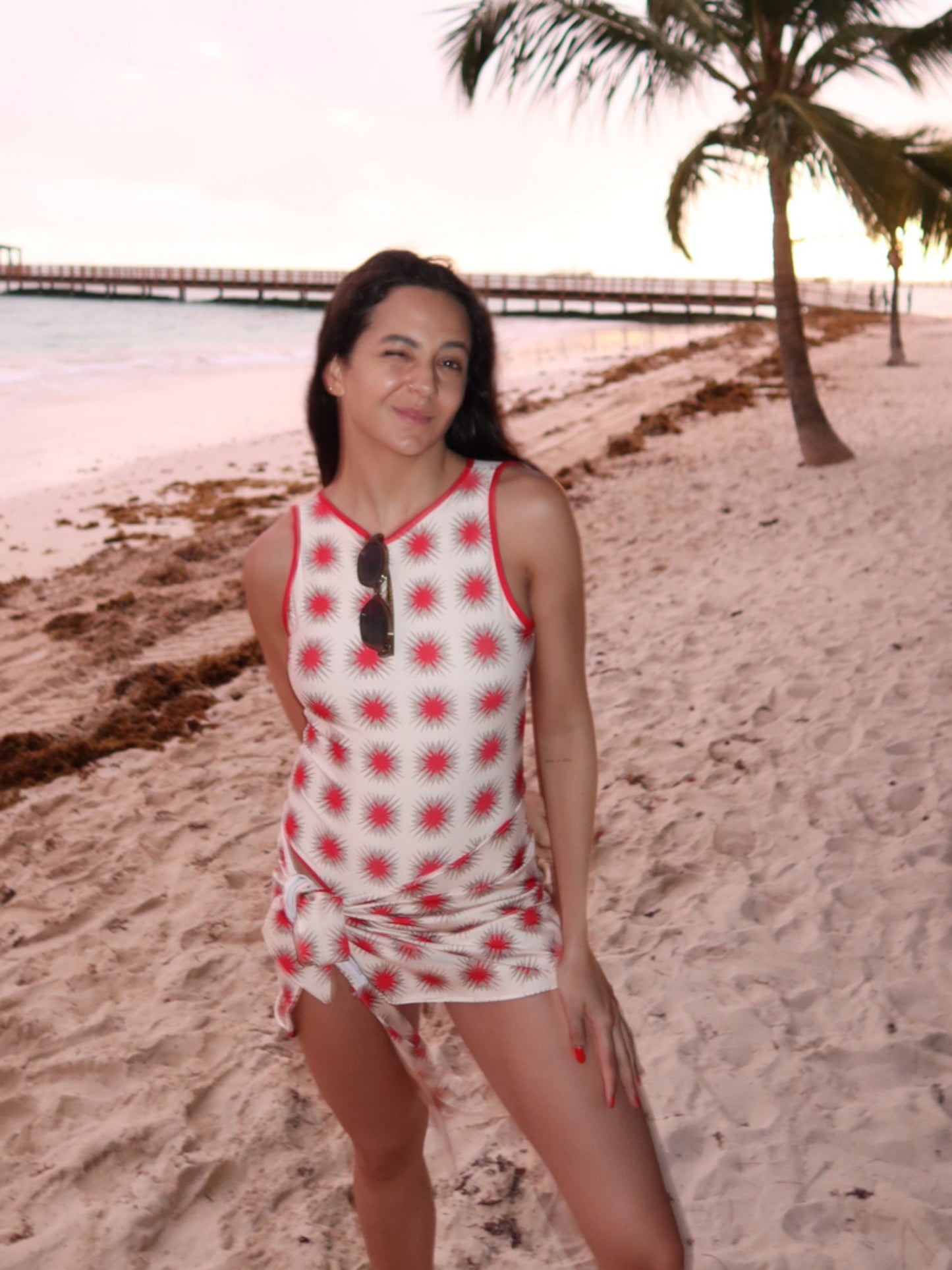 Star Red print by Encantadore worn on the beach at dusk under palm trees