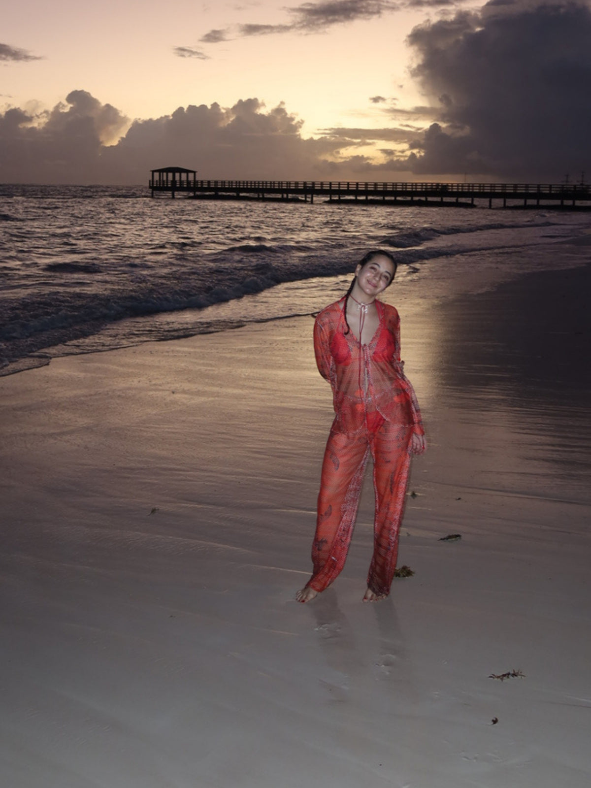 Isla Set by Bahama Mama in red, worn at the water's edge at dusk
