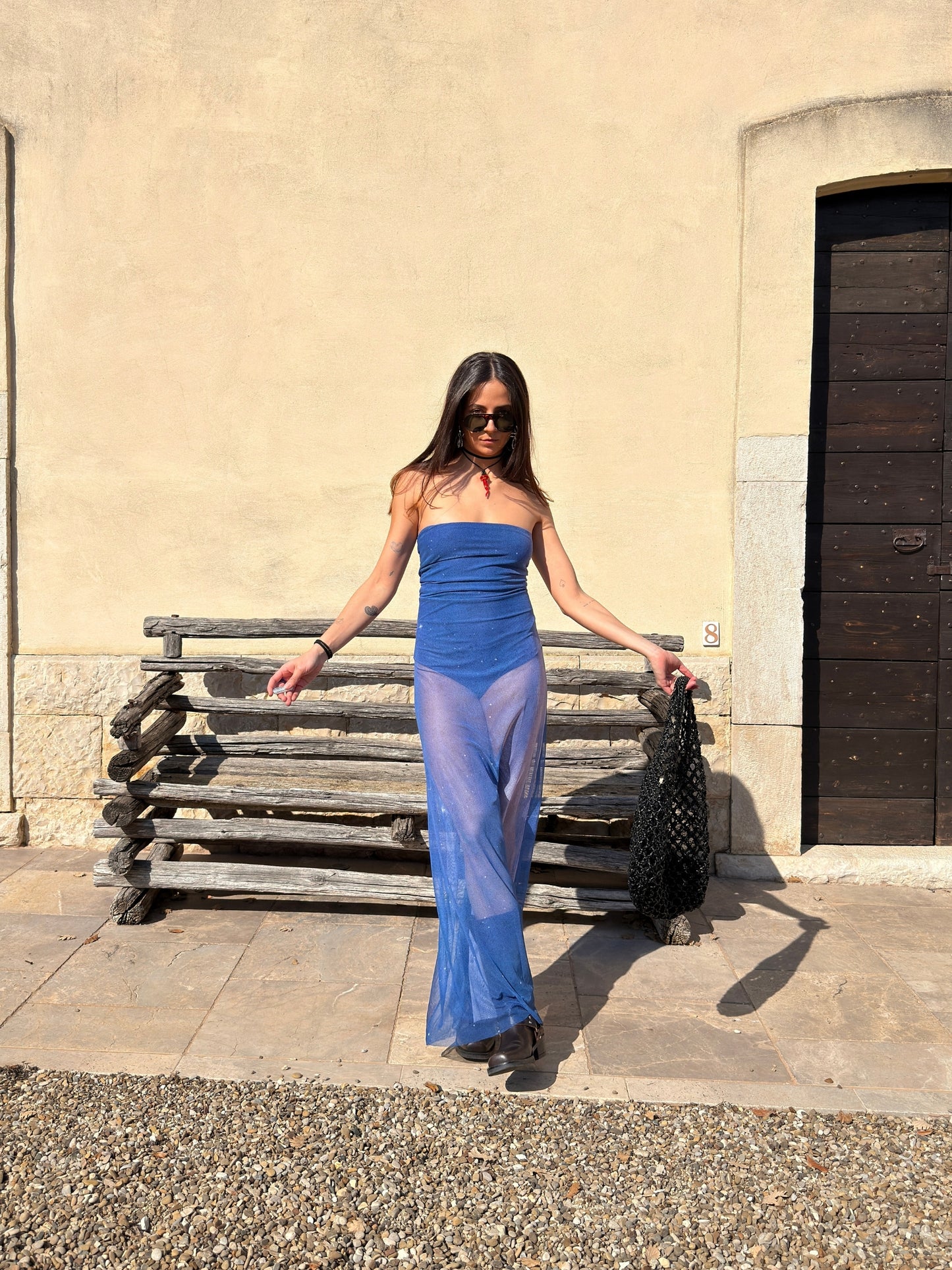 Nocturna Dress by Bahama Mama worn in a sunlit street with a black shoulder bag