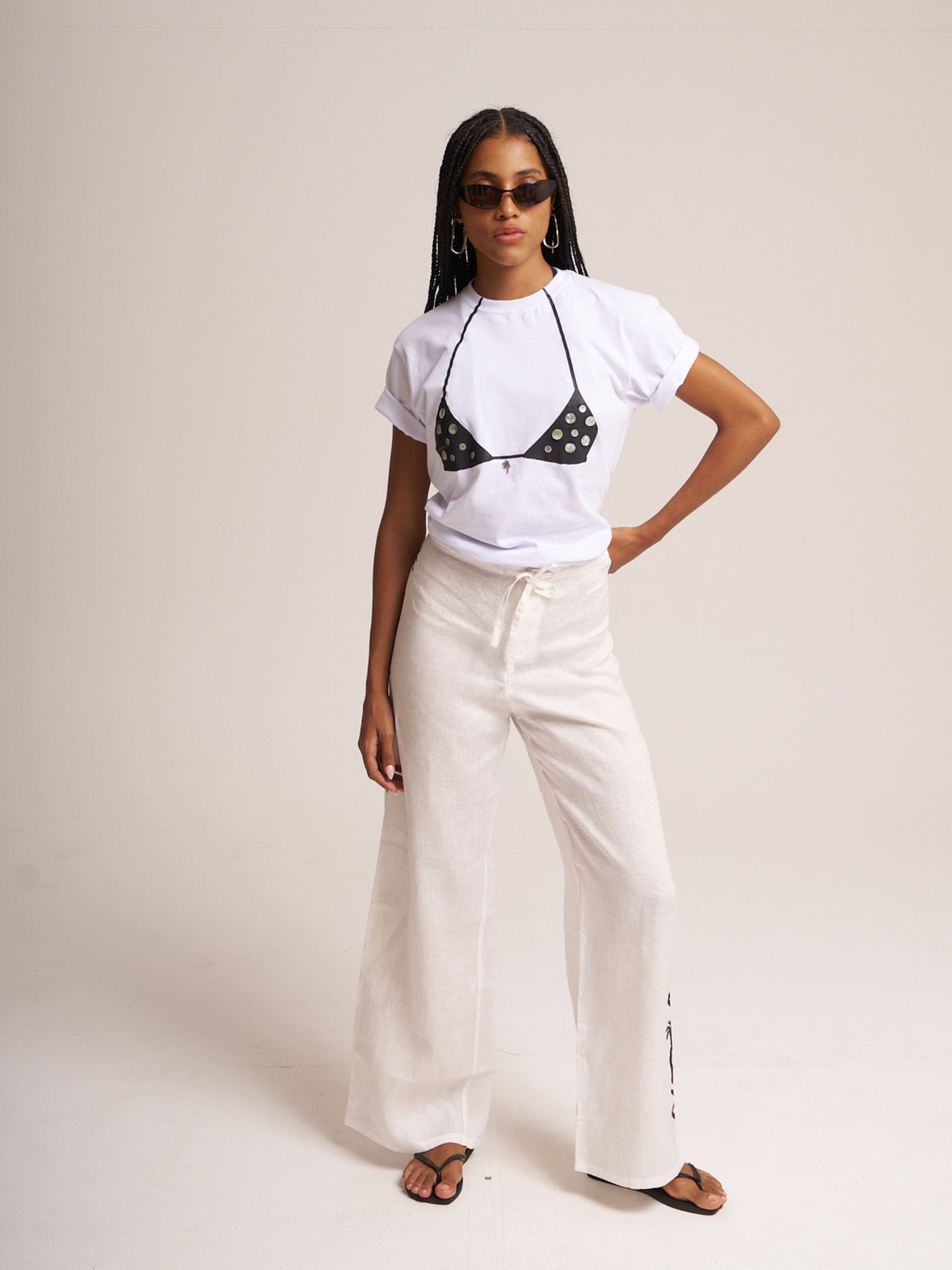 White Surreal T-shirt by Bahama Mama styled with white wide-leg trousers