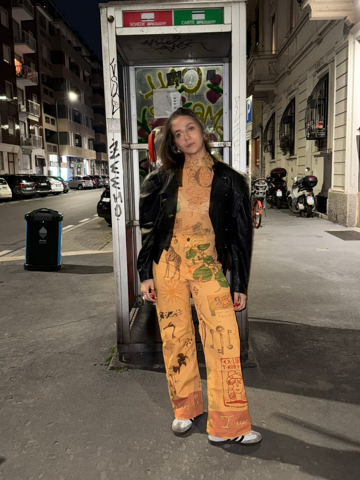 Circe Trofo printed set worn at night in a city street with a black leather jacket