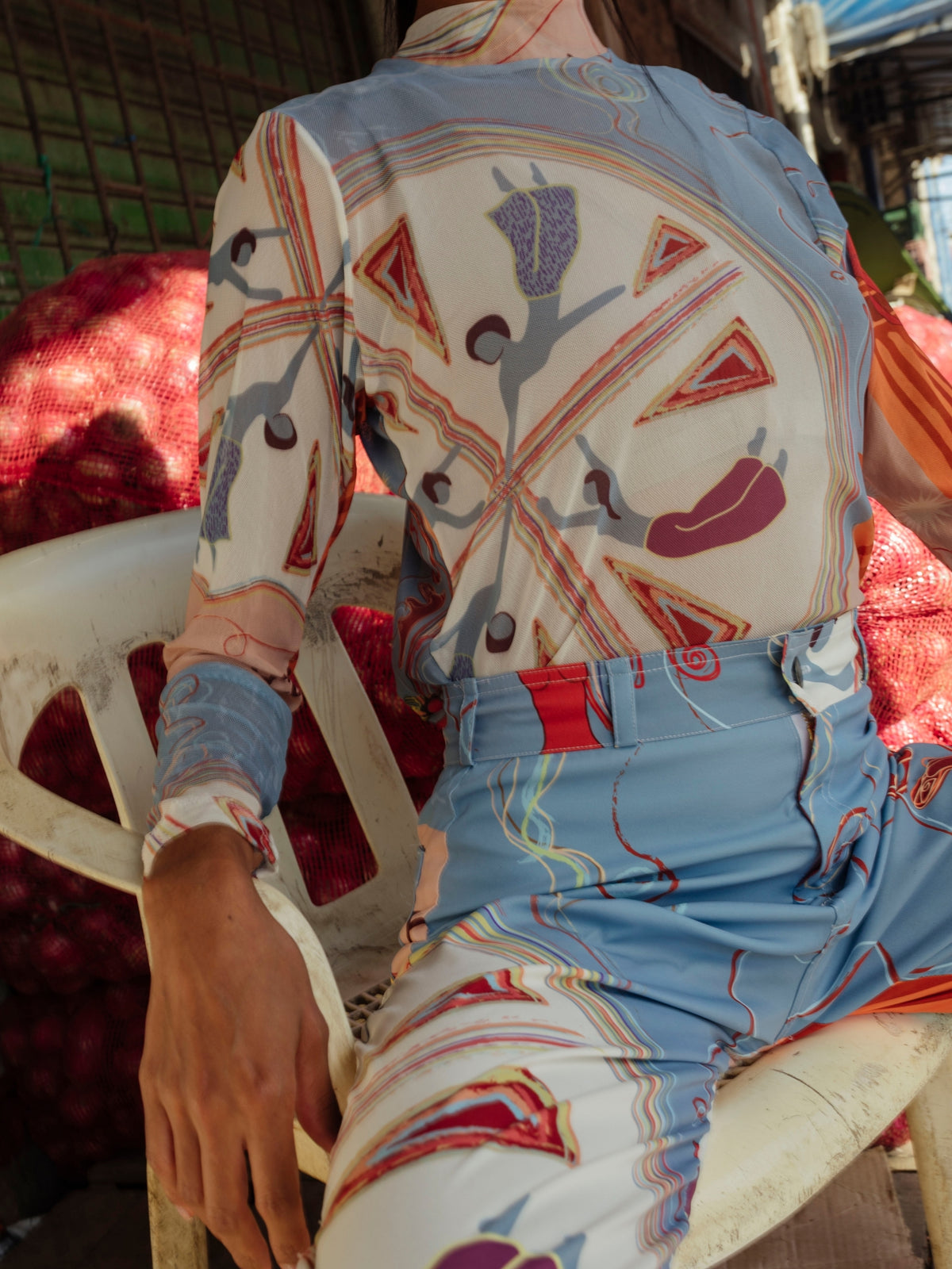 Detail of the Circe Moiras print: painted hands and figures on lightweight recycled fabric
