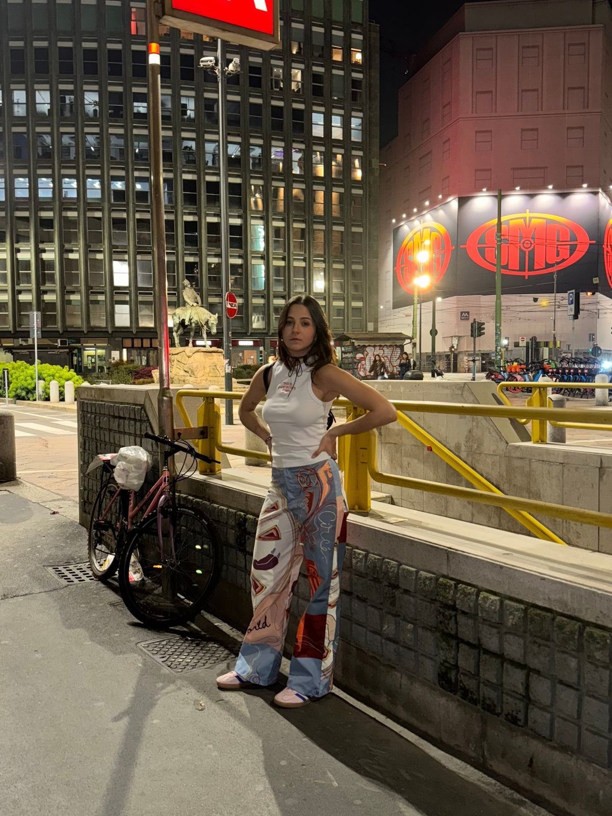 Circe Moiras printed set worn at night in a city street lit by neon signs