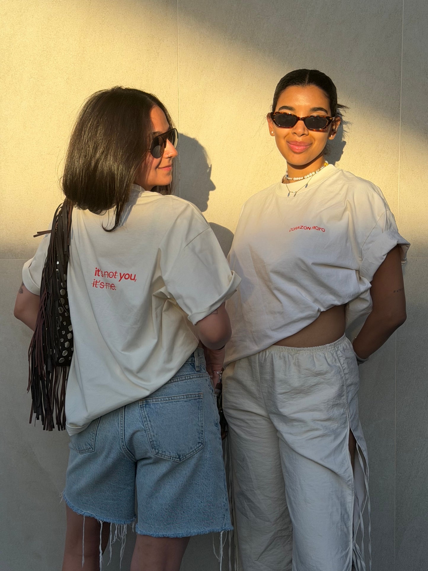 Two models in the Limited Edition CR T-shirt by Corazon Roto showing the slogan on the back