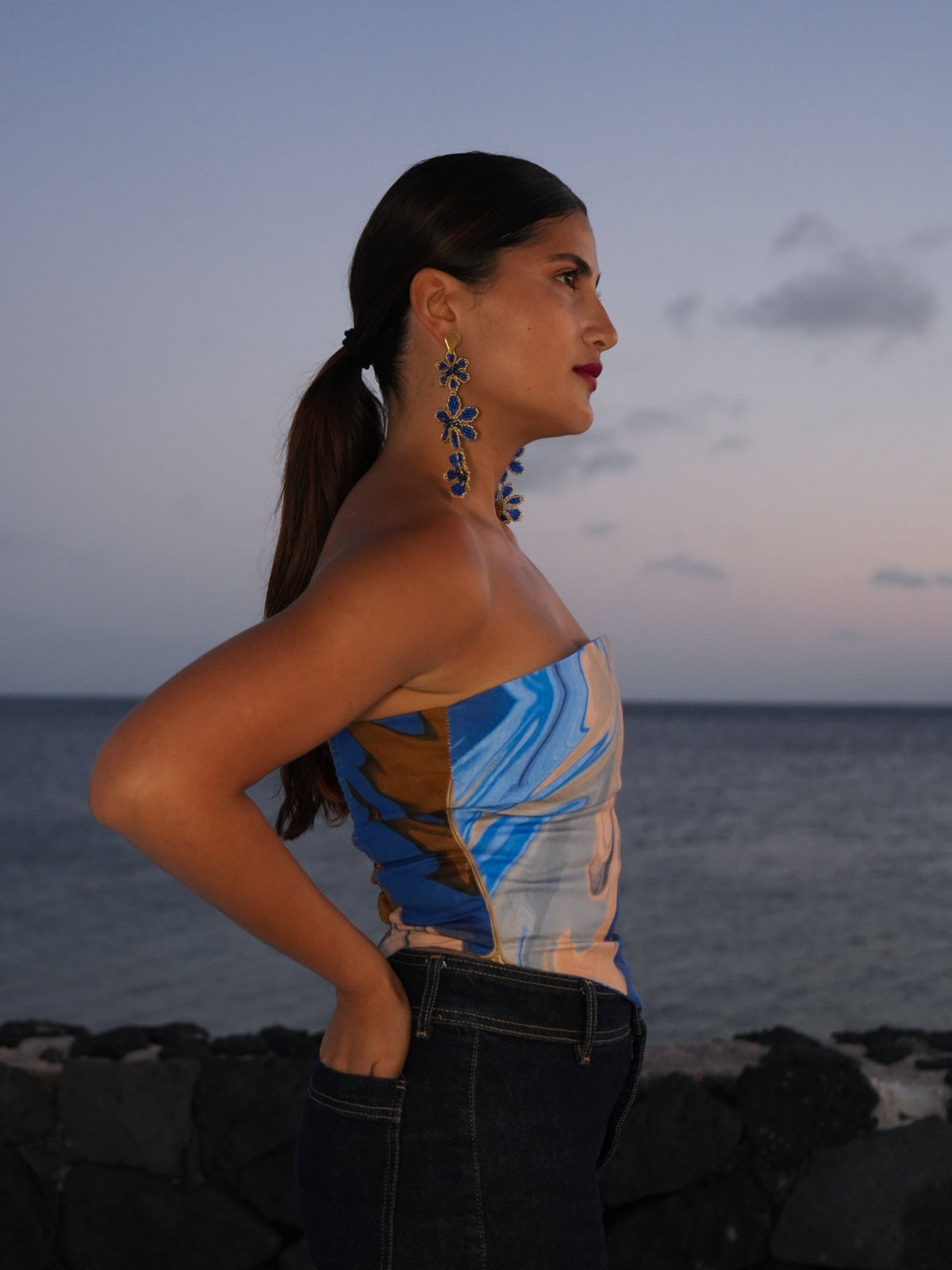 Azulita beaded flower earrings by Dearly worn at the coast at dusk