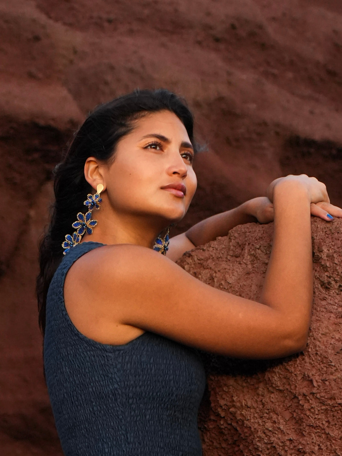 Azulita Earrings by Dearly: a long cascade of blue beaded flowers, worn against red rock