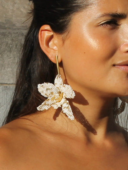 La Flor Earrings by Dearly: a large beaded ivory and gold orchid worn below the ear