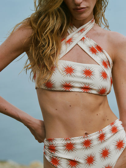Close view of the Star Red bikini by Encantadore showing the cross-neck top and ruched bottom