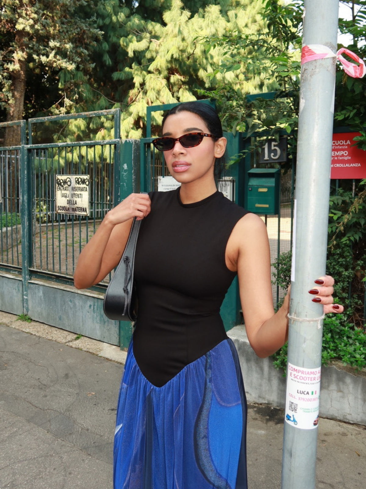 The Diving sundress by Macondia worn on a city street with sunglasses