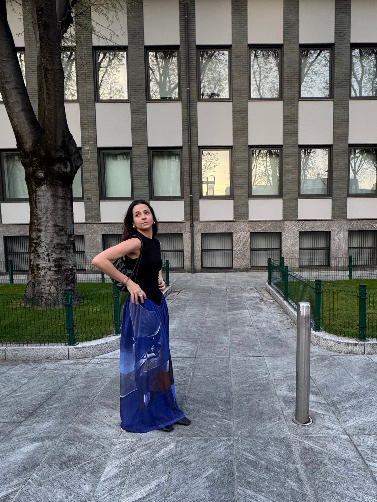Model in the Macondia Diving sundress in front of a modern building