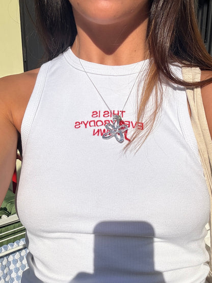 Close-up of the red slogan print on the Macondia This is Everybody's Town white tank