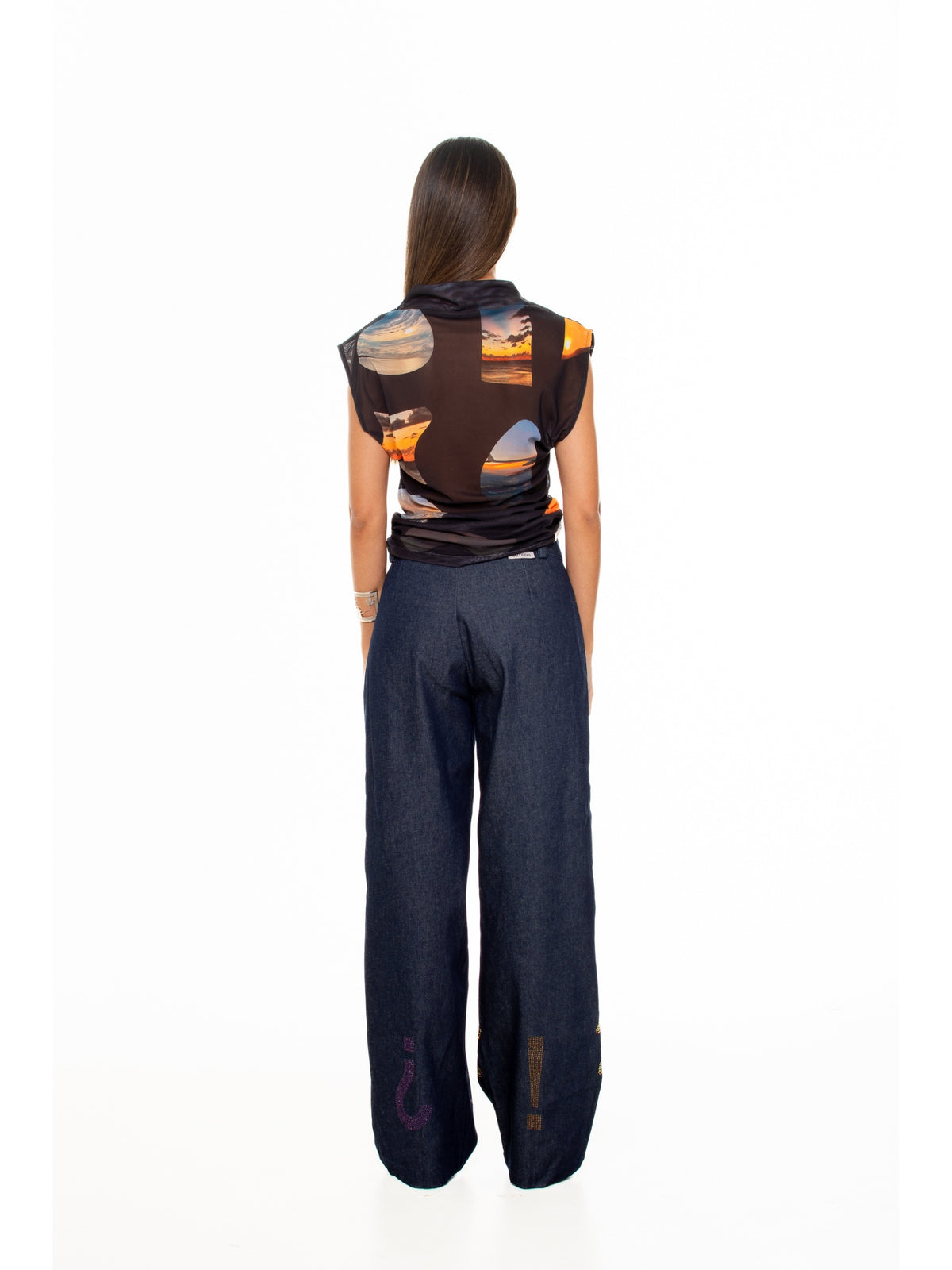 Back view of the Sunsets funnel neck top by Macondia with navy trousers