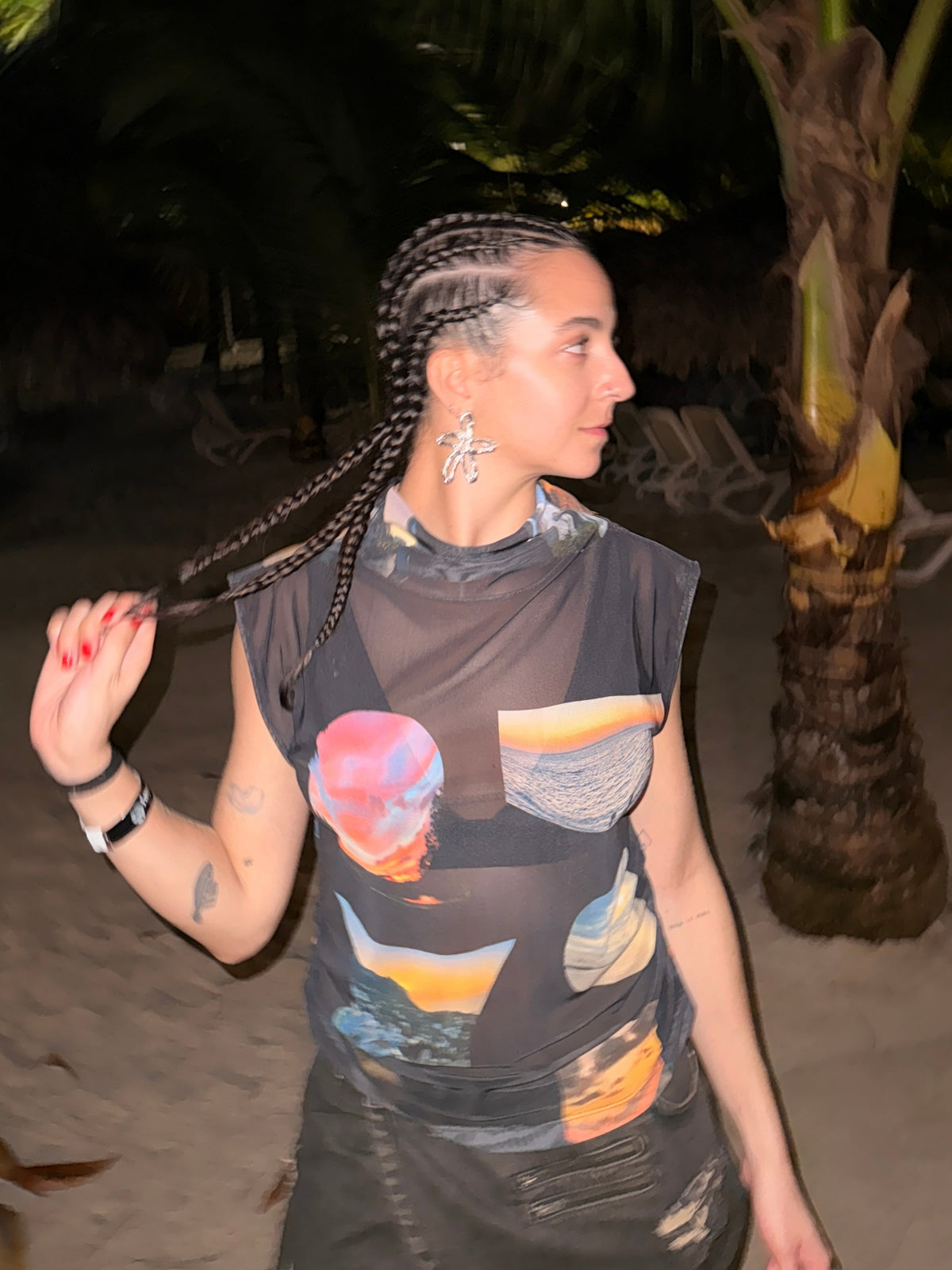The printed Sunsets funnel neck top by Macondia worn in the evening