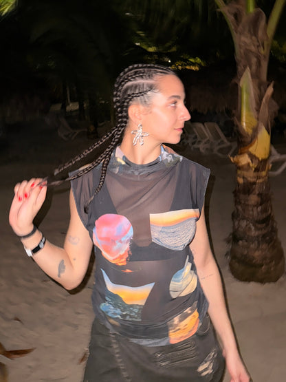 The printed Sunsets funnel neck top by Macondia worn in the evening