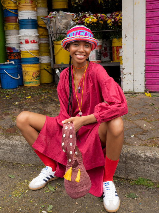 Lucky Me Crochet Hat by Pajara Pinta worn with a pink dress in a Colombian street