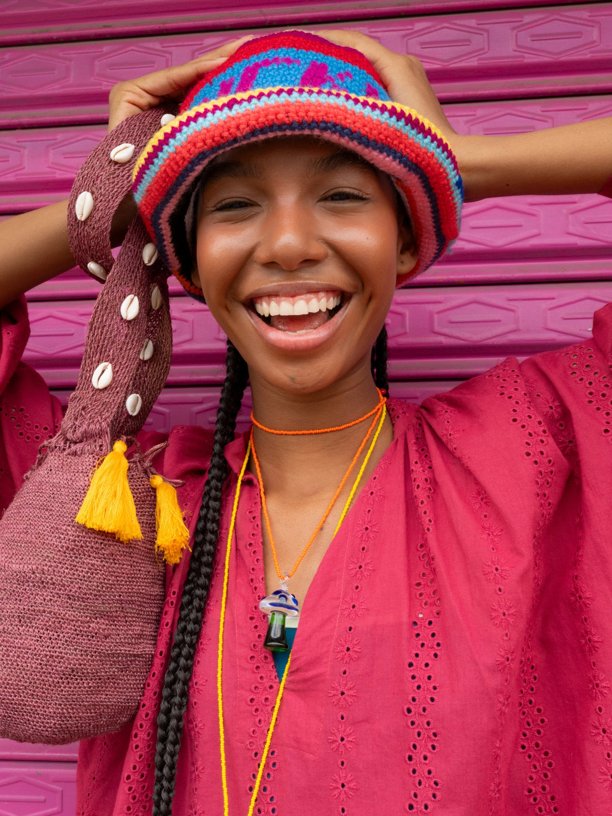 Model laughing in the Lucky Me crochet bucket hat by PÁJARA PINTA