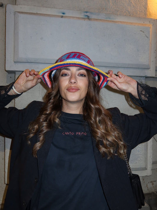 Striped crochet bucket hat by Pajara Pinta worn with a black jumper