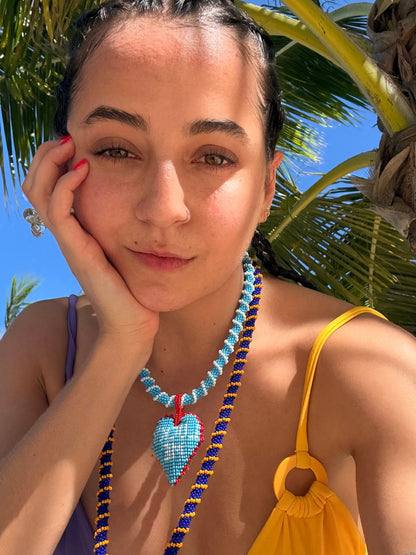 Model wearing the Short Lucky Me beaded necklace by PÁJARA PINTA with a yellow bag