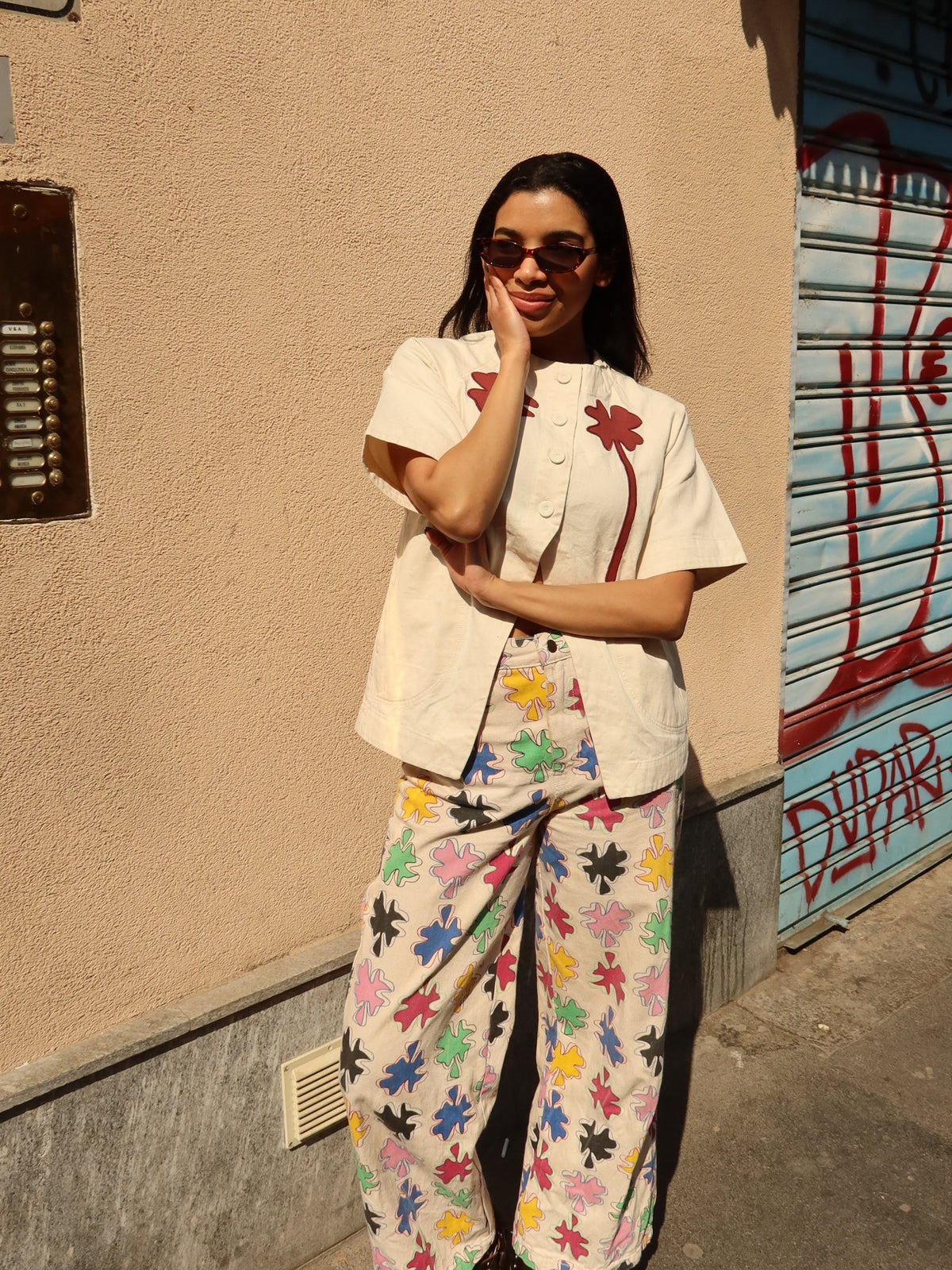 The Amulet Chill Jeans by SIXXTA worn with a cream shirt on a city street