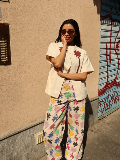 The Amulet Chill Jeans by SIXXTA worn with a cream shirt on a city street