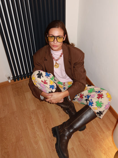 Model seated in the SIXXTA Amulet Chill Jeans with a brown blazer and boots