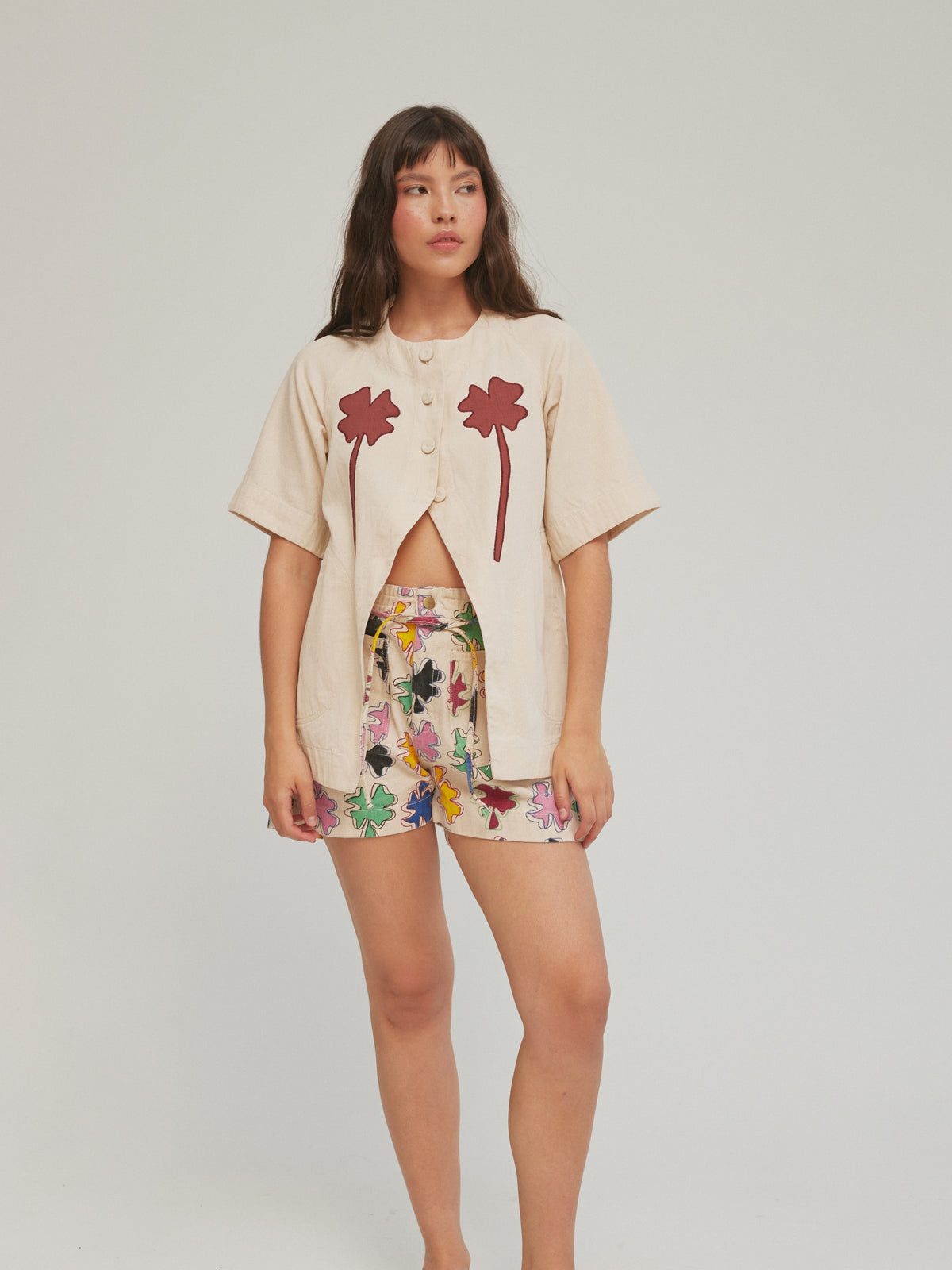 Full-length view of the SIXXTA Clover Fortune Top Red with printed shorts