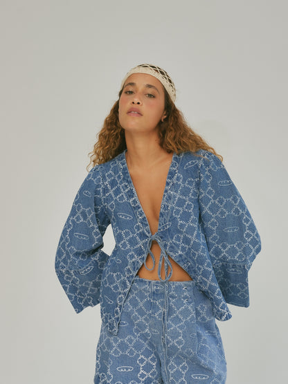 The SIXXTA Panes denim top worn with flared sleeves and matching printed jeans