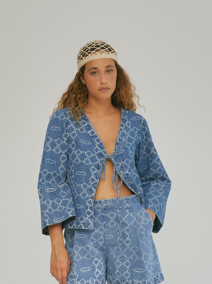 Studio view of the SIXXTA Panes Jean Top with its tie front and wide sleeves