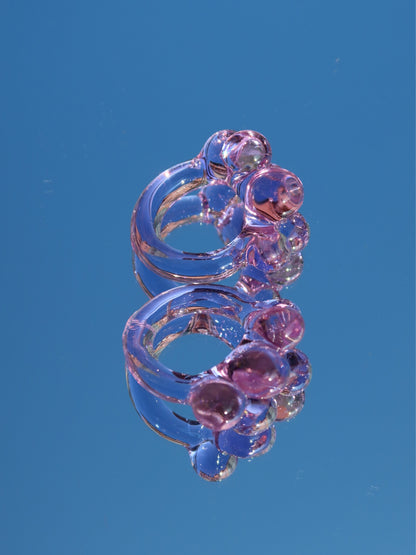 Bubbles Purple Ring by VOLD: a handmade lilac glass ring photographed against the sky
