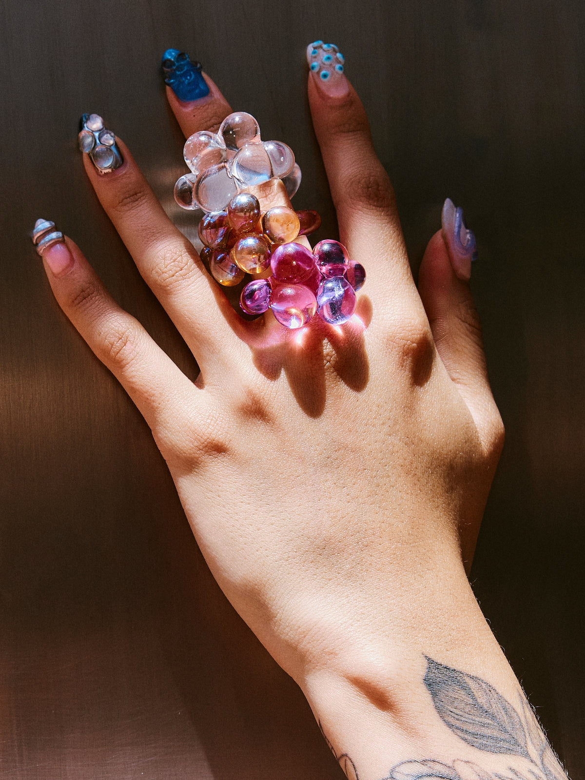 Several VOLD Bubbles glass rings worn together on one hand