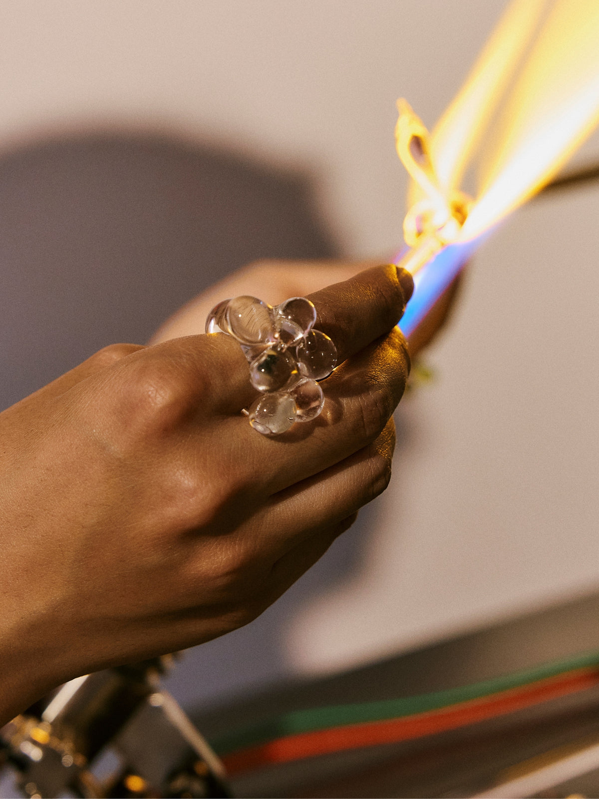 A VOLD Bubbles Transparent glass ring being shaped in the flame
