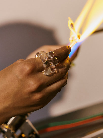 A VOLD Bubbles Transparent glass ring being shaped in the flame