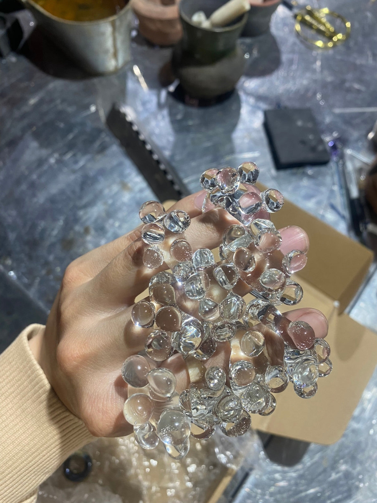 A handful of VOLD Bubbles Transparent glass rings in the workshop