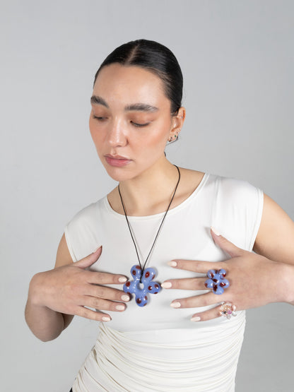 VOLD Paradise Flower Charm Necklace worn long with the matching Paradise rings