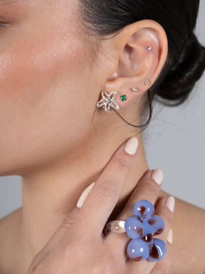 VOLD Paradise Maxi Flower glass ring worn on a hand raised to the neck