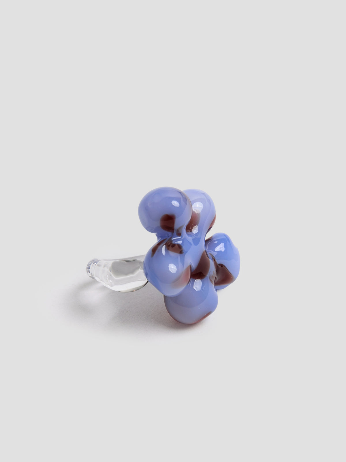 Close view of the handmade light blue and burgundy glass flower ring by VOLD
