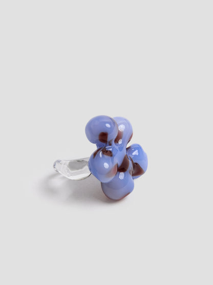 Close view of the handmade light blue and burgundy glass flower ring by VOLD